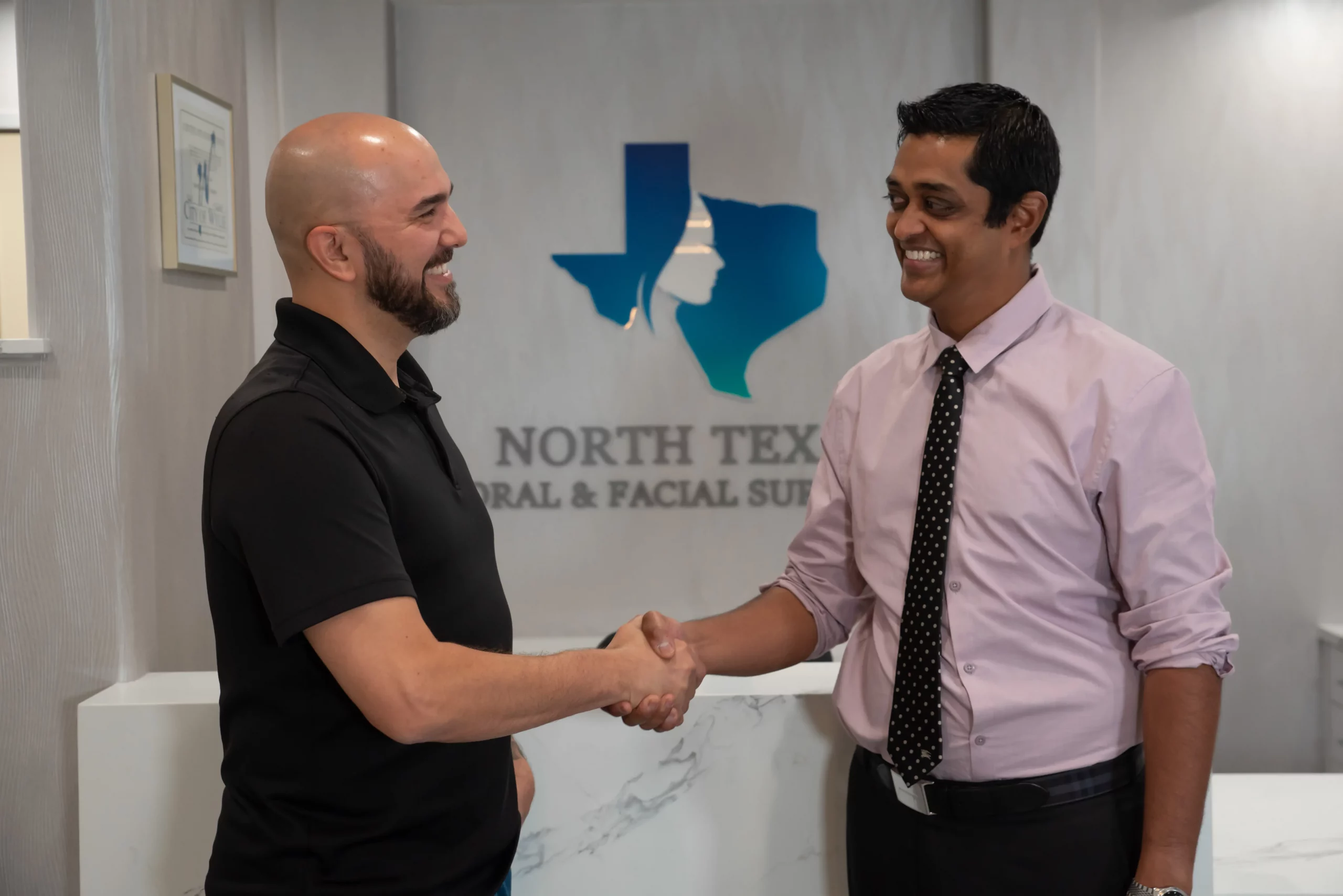 oral surgeon shaking hands with a happy patient after oral surgery in wylie tx