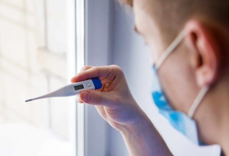 Young Man With A Thermometer